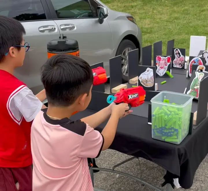 Children actively playing and enjoying the Nerf target game at an event
